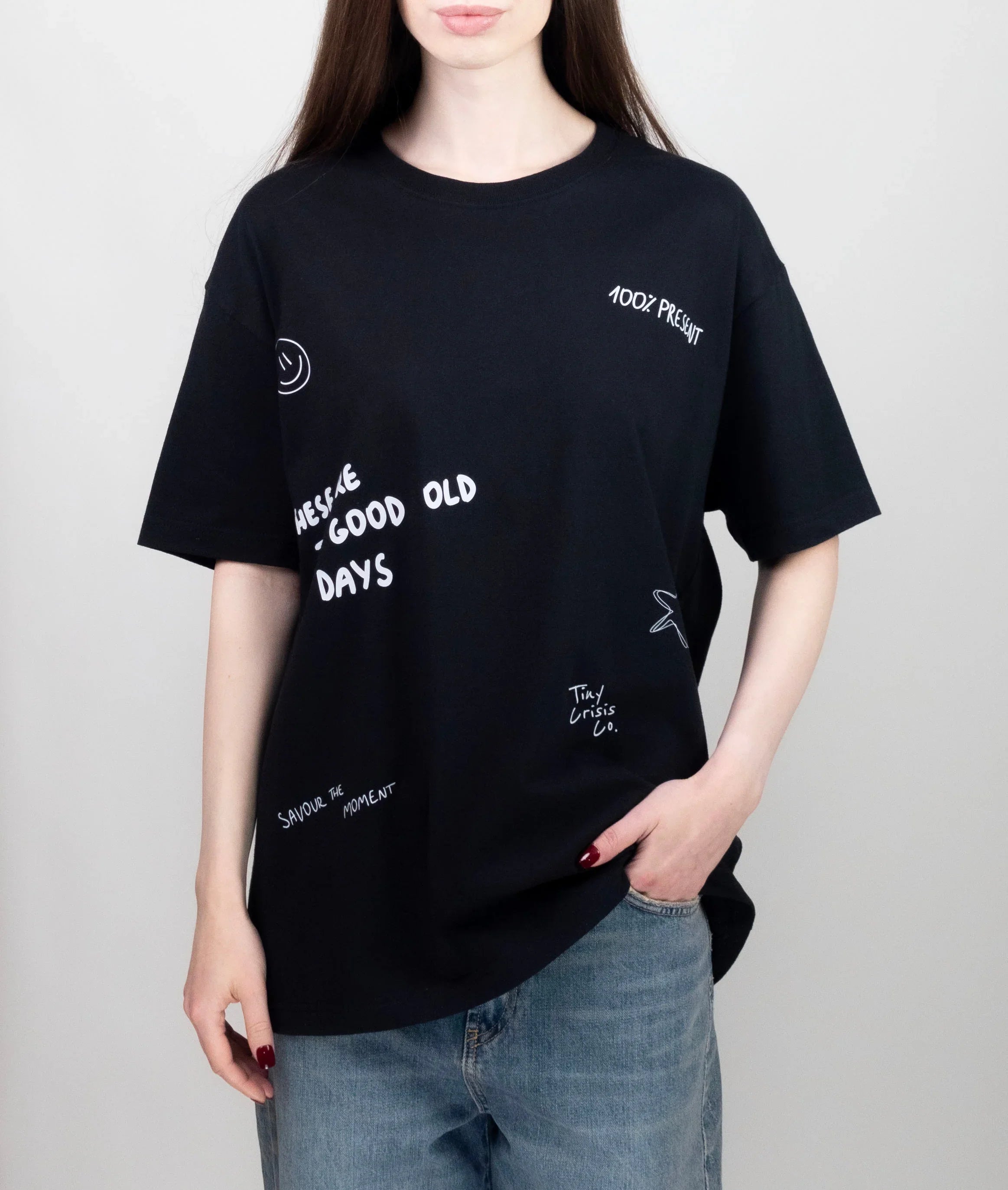 Person wearing a black t-shirt with white text on a plain background