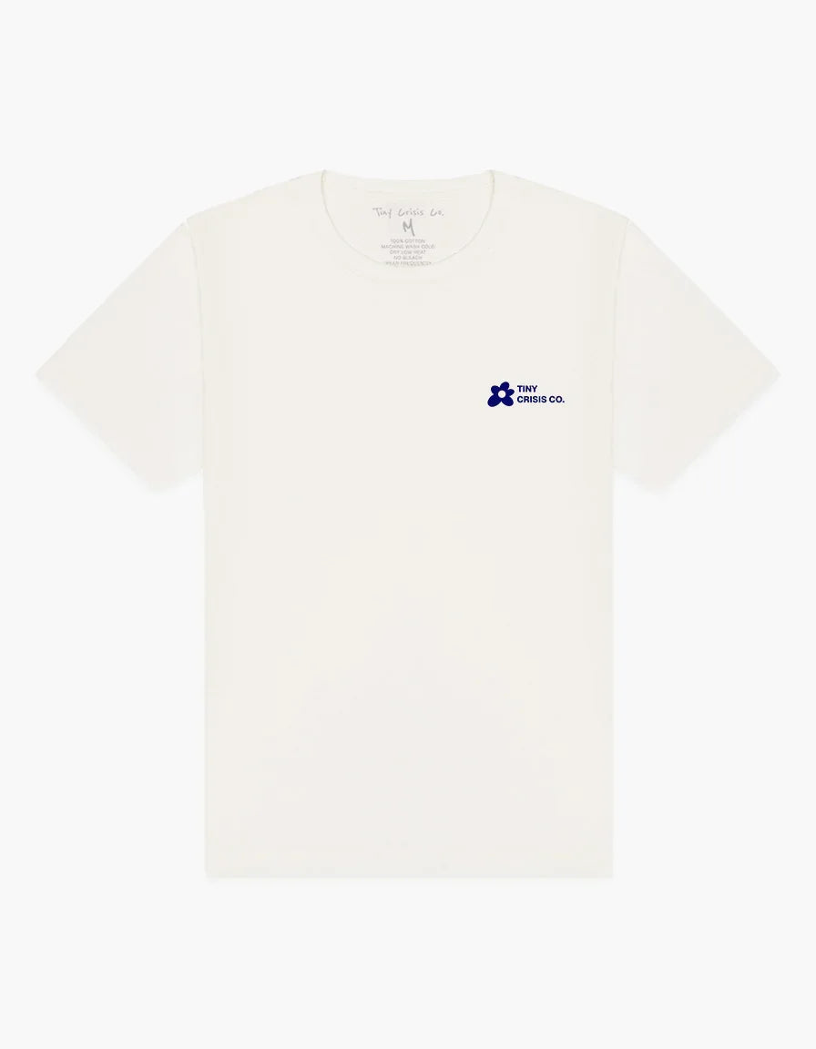 Beige t-shirt with a small blue logo on a white background