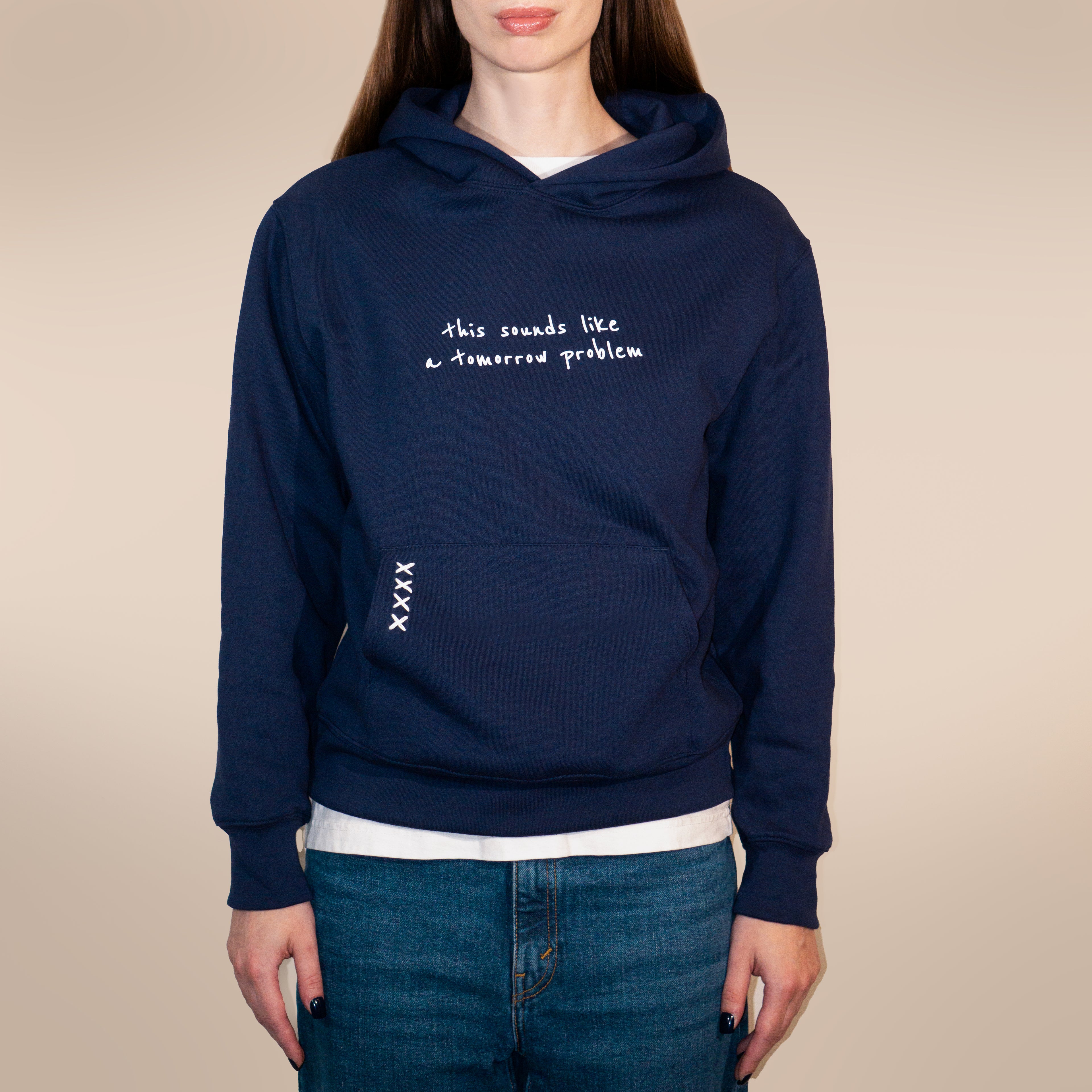Navy blue hoodie with text on a beige background